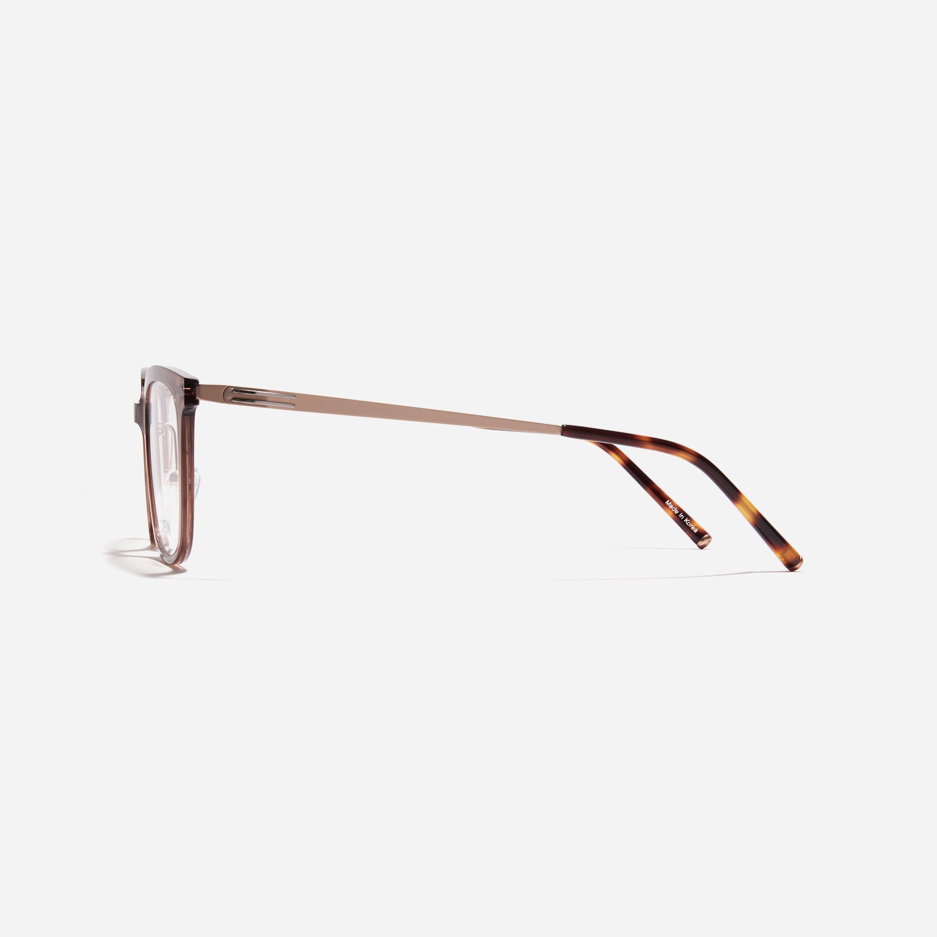 Square-shaped combination eyeglasses from CARIN's 'Feather Fit' line. Their combination frame seamlessly blends bio-plastic and titanium, utilizing advanced injection molding technology, often seen in the manufacturing of cell phones and watches.