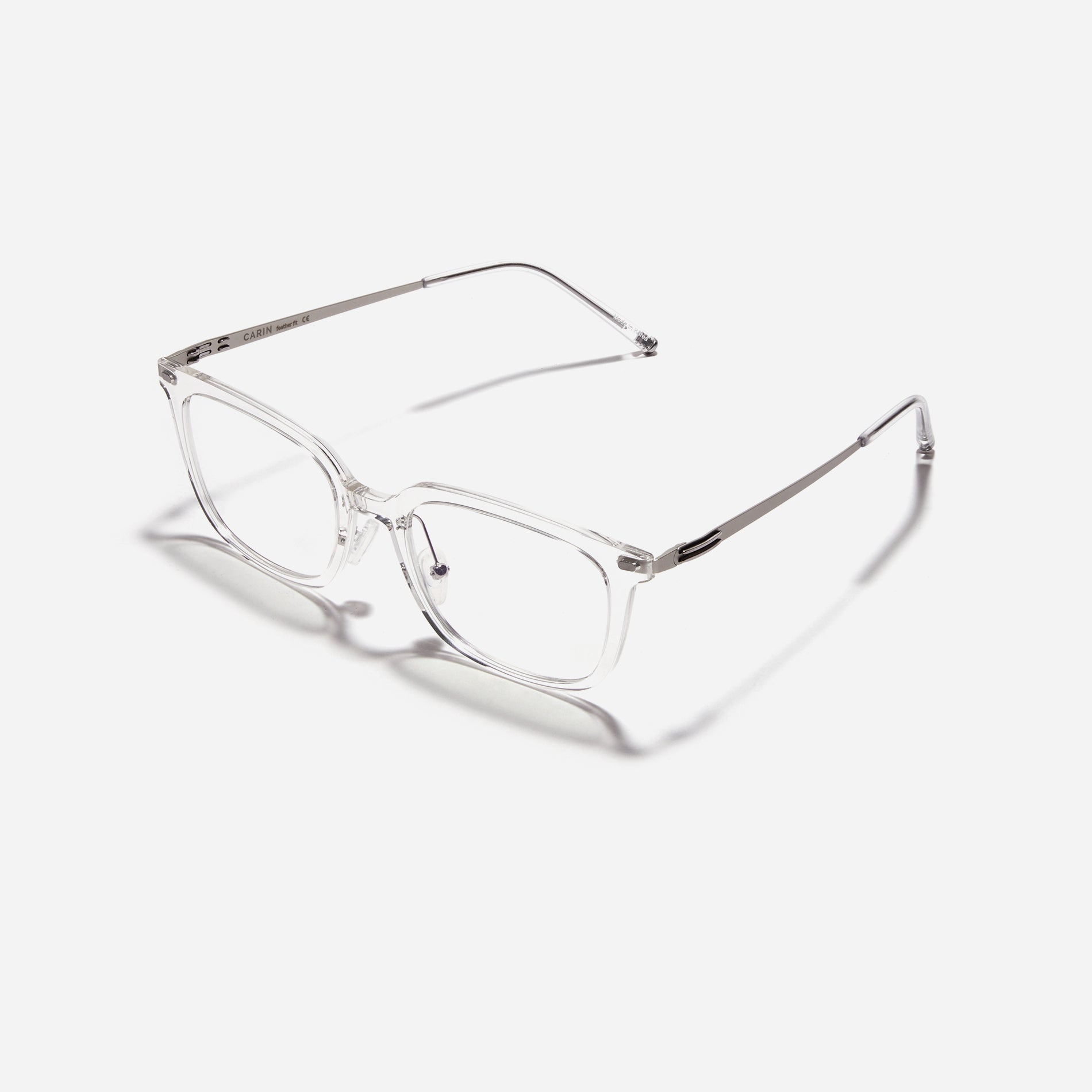 Square-shaped combination eyeglasses from CARIN's 'Feather Fit' line. Their combination frame seamlessly blends bio-plastic and titanium, utilizing advanced injection molding technology, often seen in the manufacturing of cell phones and watches.
