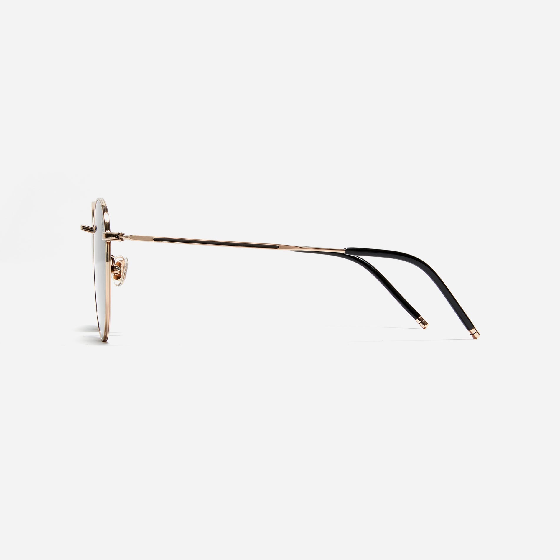 Round-shaped metal sunglasses that offer a soft and natural look with a peach-shaded titanium frame.