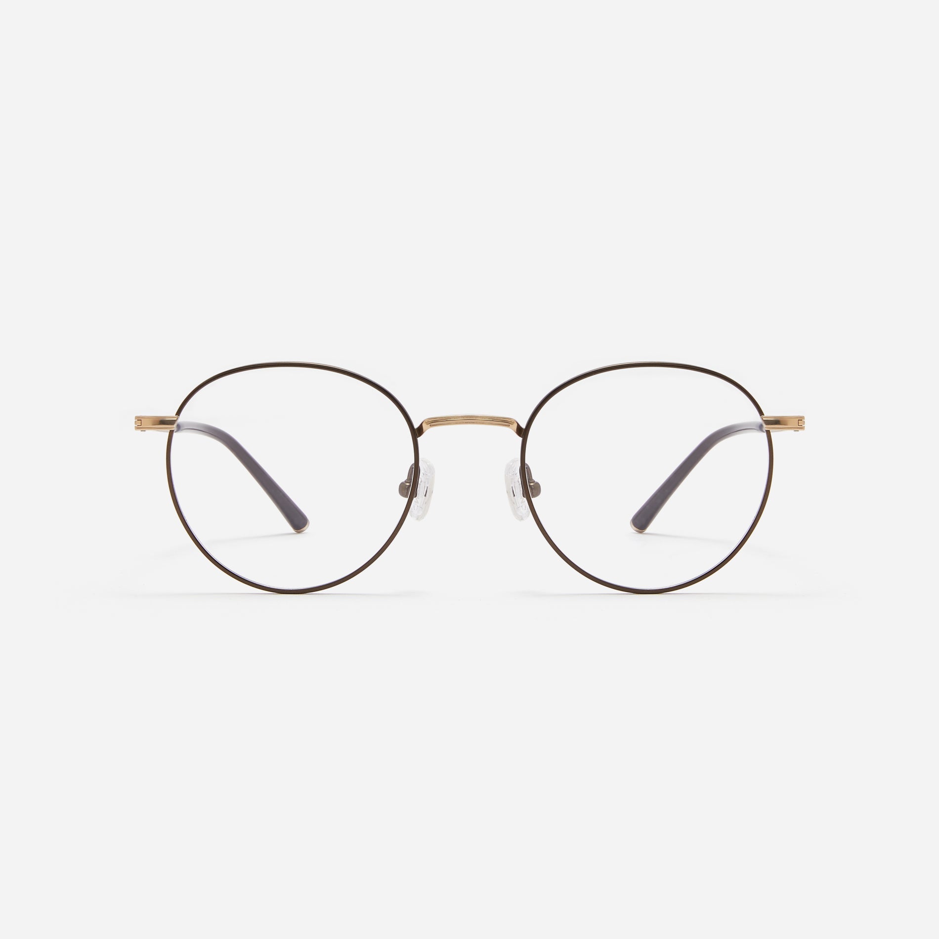 Round-shaped blue light blocking eyeglasses. Crafted entirely from pure titanium, they offer a lightweight and comfortable wearing experience. The three-dimensional lining details on the frame and temples, combined with epoxy and matte plating, enhance its classic ambiance.