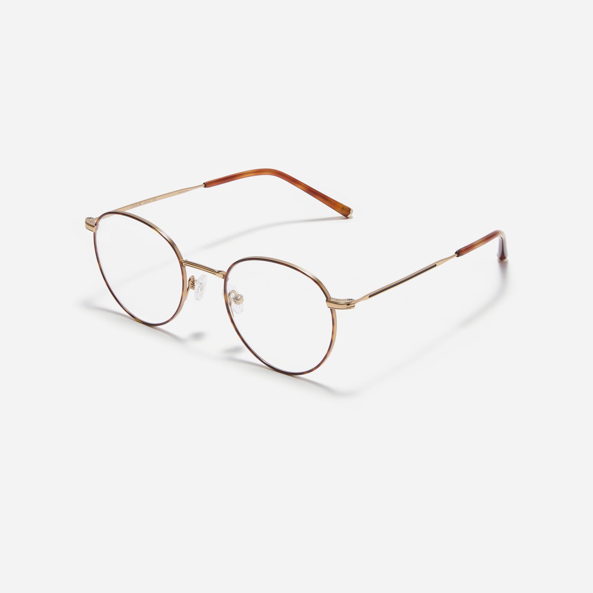 Round-shaped blue light blocking eyeglasses. Crafted entirely from pure titanium, they offer a lightweight and comfortable wearing experience.  The three-dimensional lining details on the frame and temples, combined with epoxy and matte plating, enhance its classic ambiance. 
