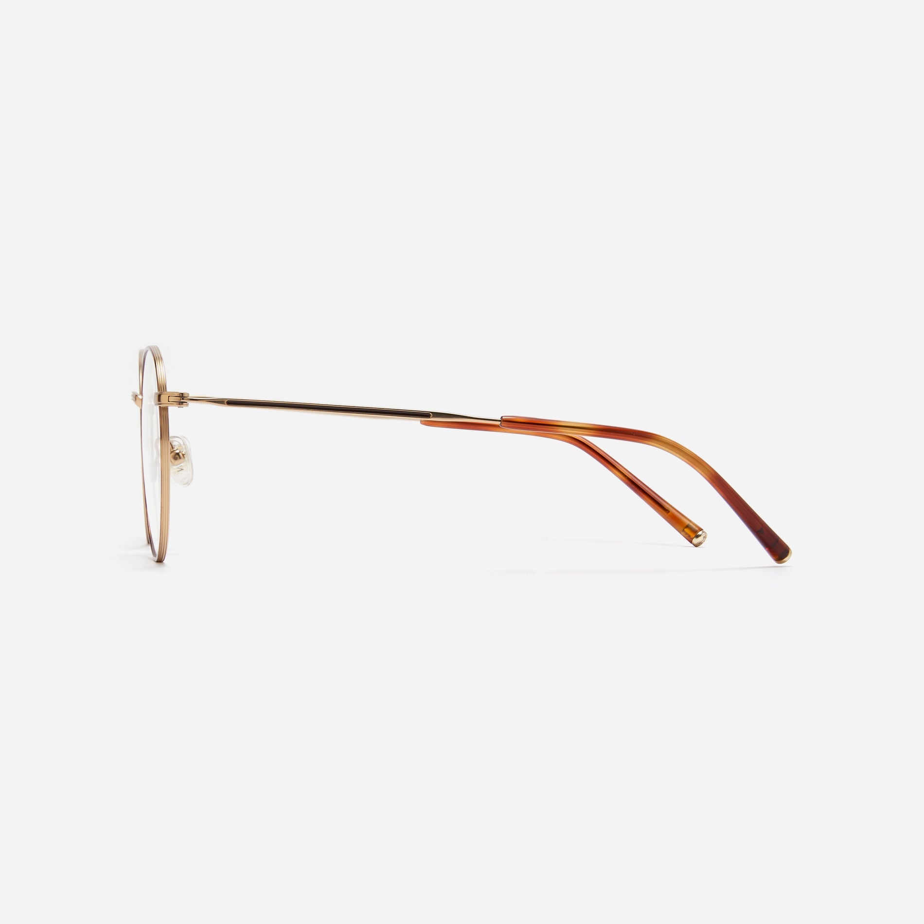 Round-shaped blue light blocking eyeglasses. Crafted entirely from pure titanium, they offer a lightweight and comfortable wearing experience.  The three-dimensional lining details on the frame and temples, combined with epoxy and matte plating, enhance its classic ambiance. 
