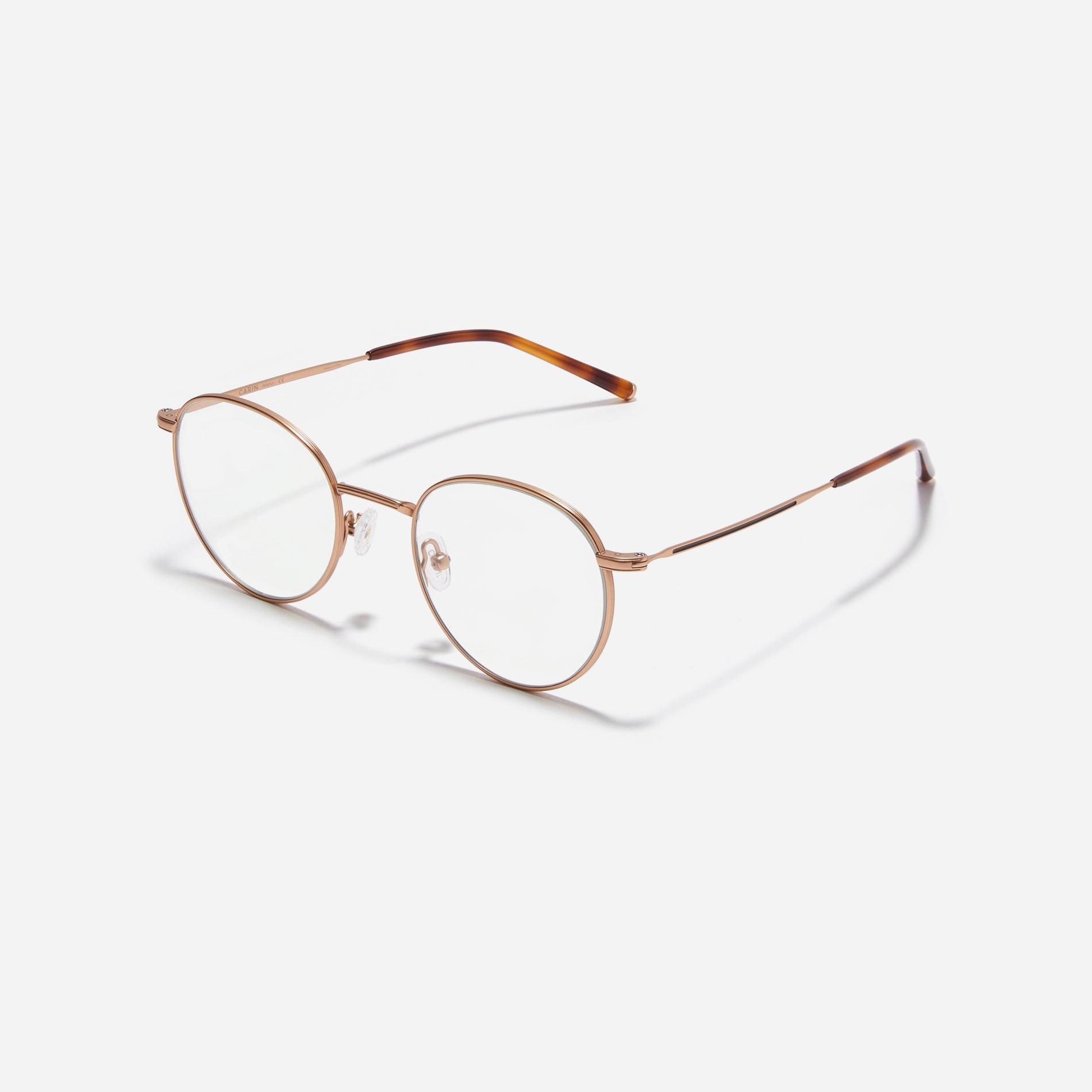 Round-shaped blue light blocking eyeglasses. Crafted entirely from pure titanium, they offer a lightweight and comfortable wearing experience.  The three-dimensional lining details on the frame and temples, combined with epoxy and matte plating, enhance its classic ambiance. 
