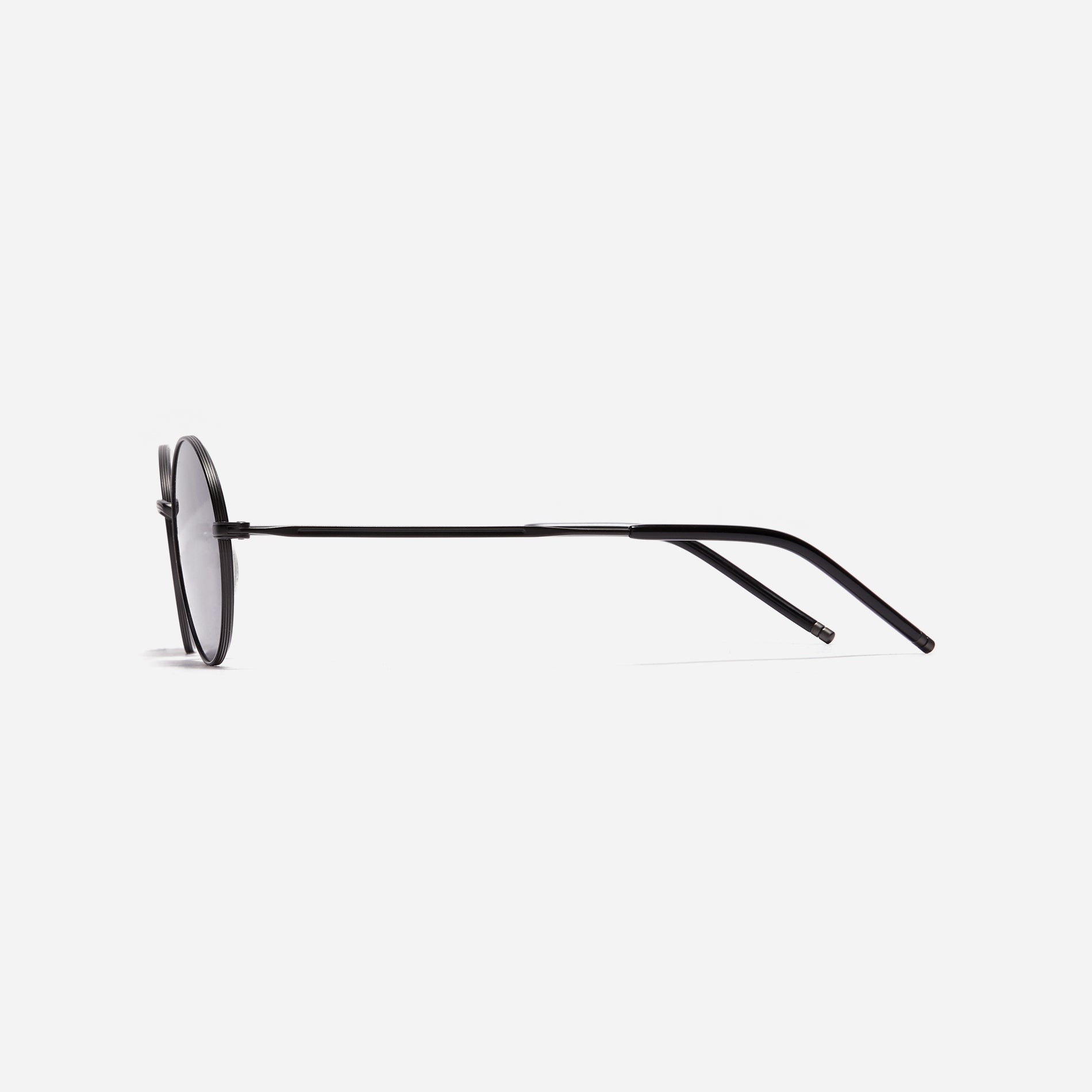 Tinted sunglasses with an oval frame crafted entirely from titanium.