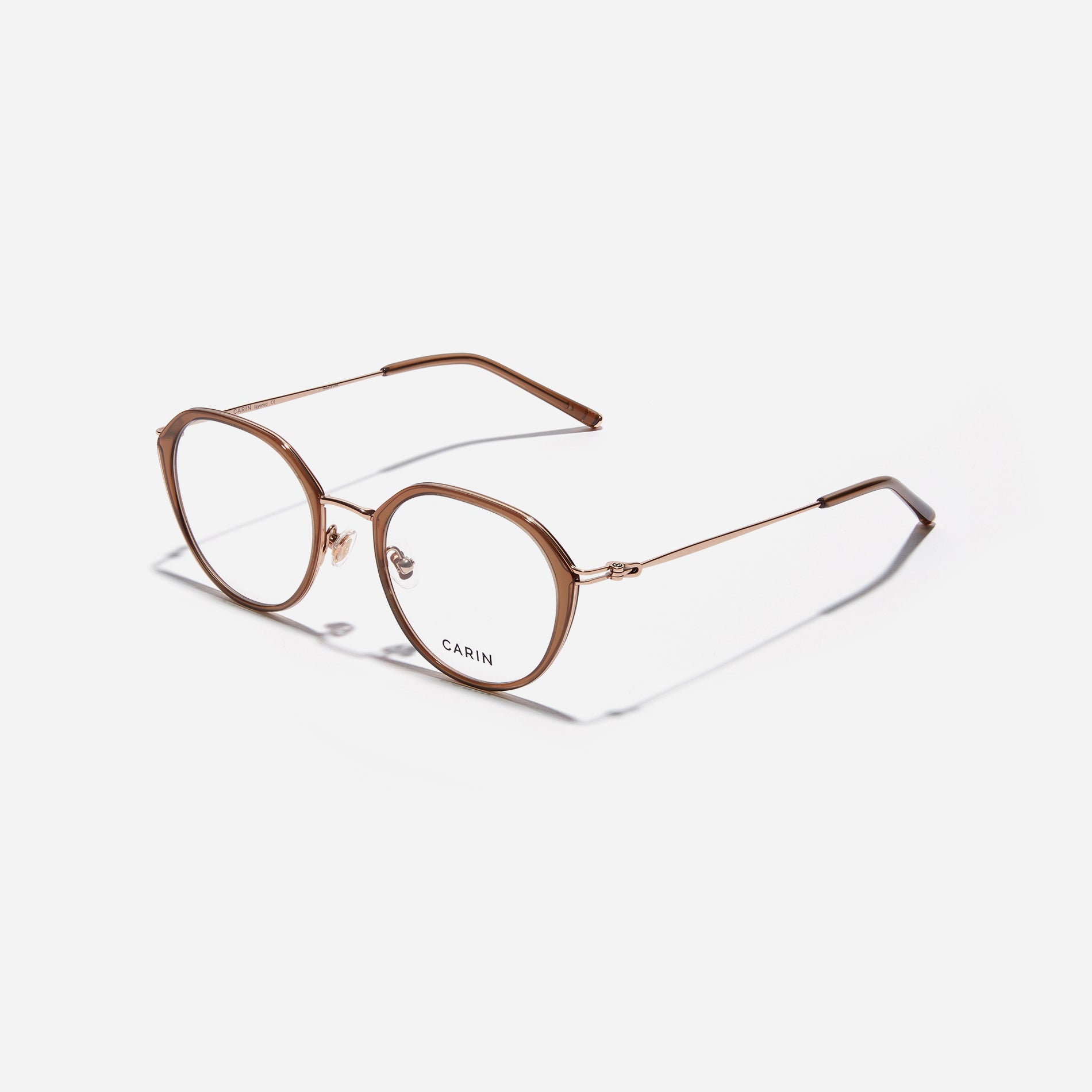 Polygonal-shaped eyeglasses that feature a contrasting round lens design, offering a smooth yet refined style.  They provide a comfortable wearing experience with slim temples made from lightweight and elastic B-Titanium material.