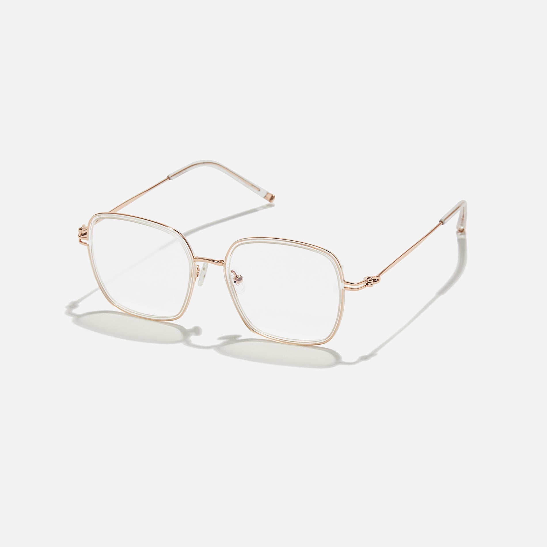 Rectangular-shaped oversized eyeglasses  characterized by a delicate acetate rim that secures the frame and hinge details.  The slim temples, made from lightweight and elastic B-Titanium material, ensure a consistently comfortable fit.