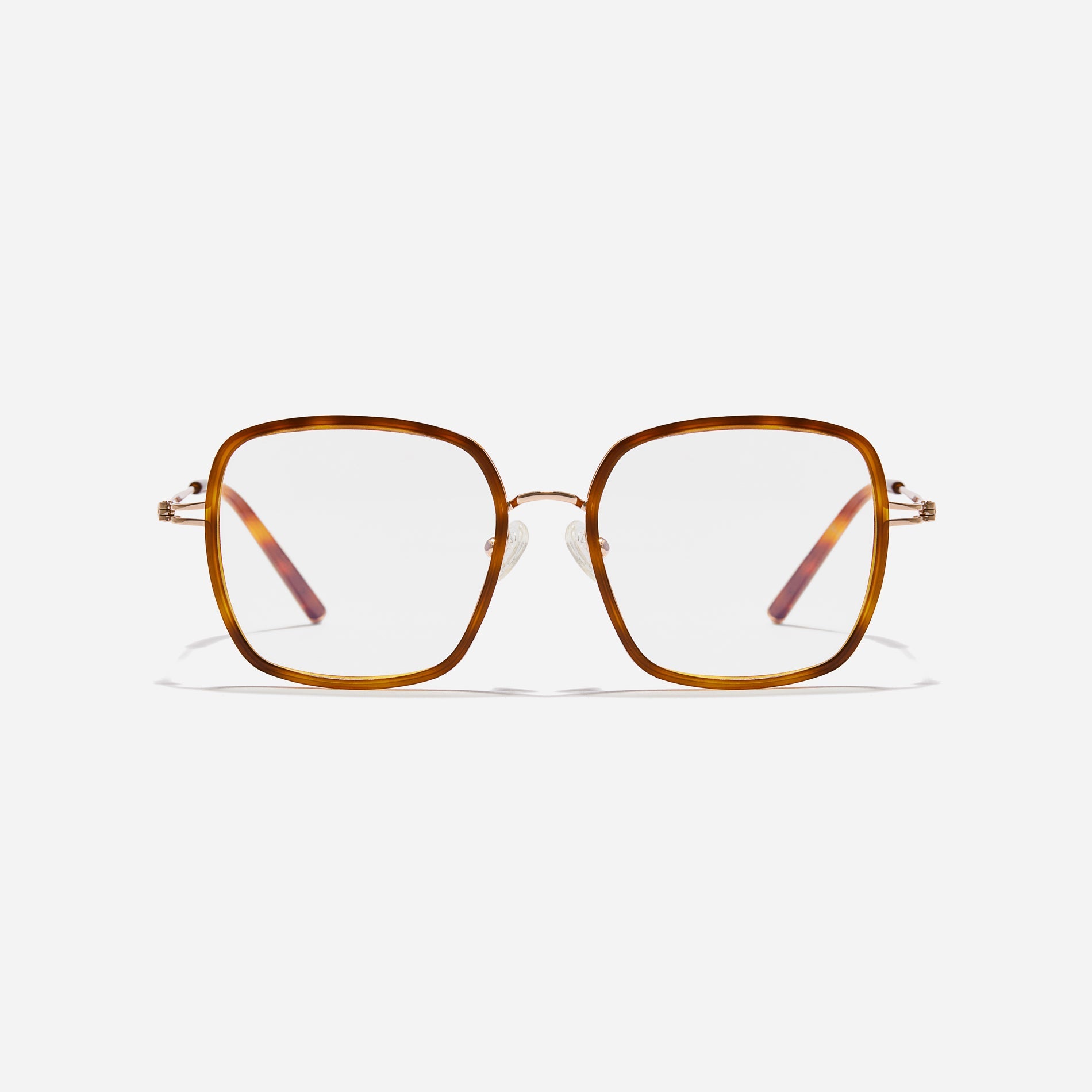 Rectangular-shaped oversized eyeglasses  characterized by a delicate acetate rim that secures the frame and hinge details.  The slim temples, made from lightweight and elastic B-Titanium material, ensure a consistently comfortable fit.